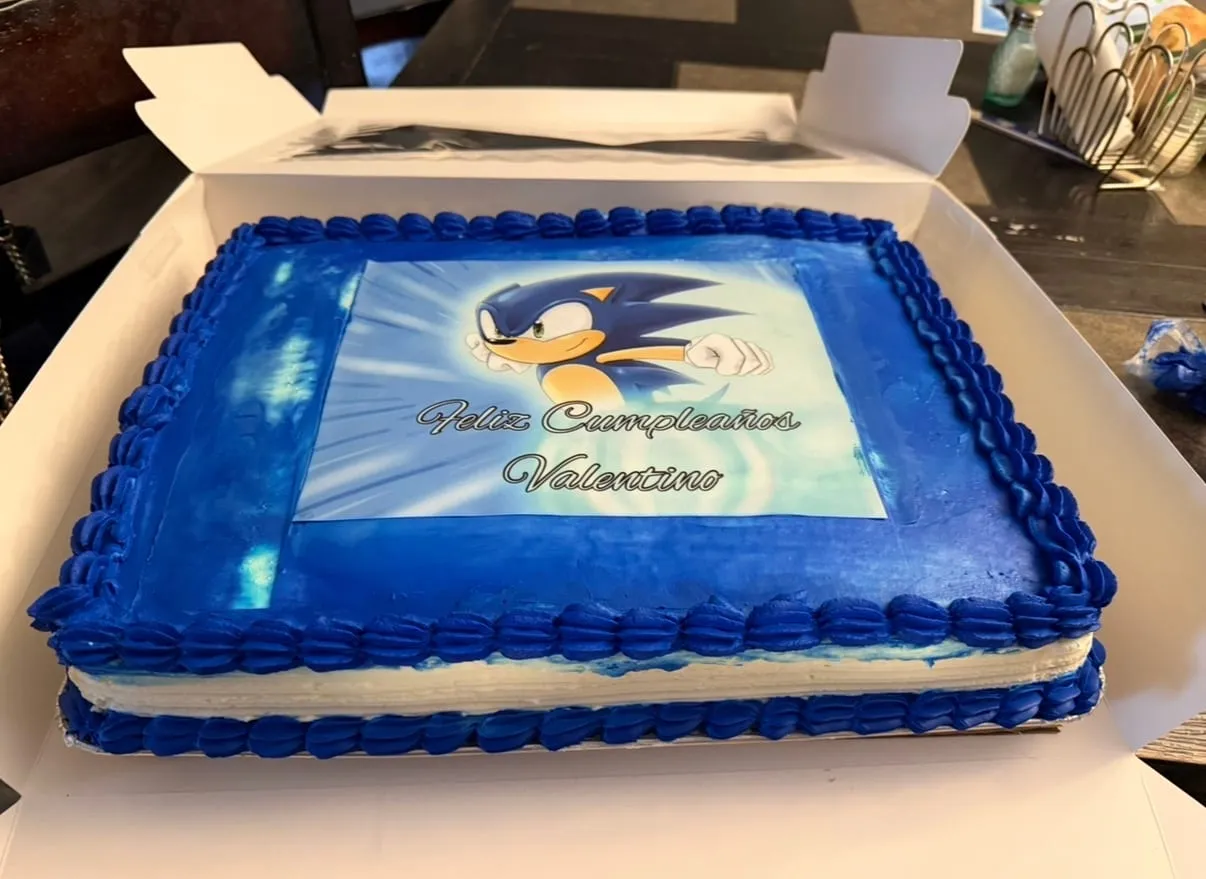 Sonic the Hedgehog birthday sheet cake with a blue edible image and blue shell borders